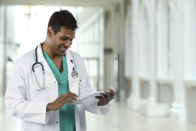 Doctor looks at patient information on tablet