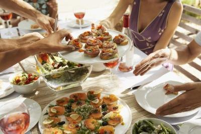 People help themselves to assorted appetizers.