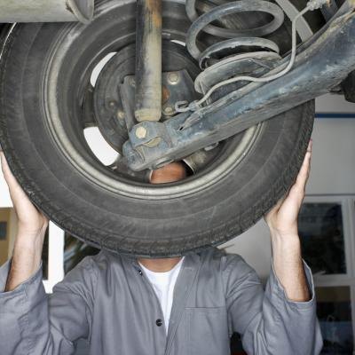 Mechanic inspecting wheel