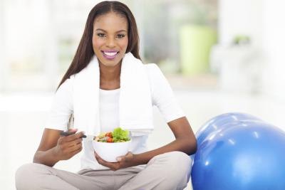 Young woman eating a healthy meal after a workout