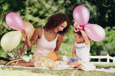 Mother celebrating daughters birthday outdoors