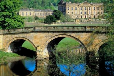 A stone arch bridge spans a river.