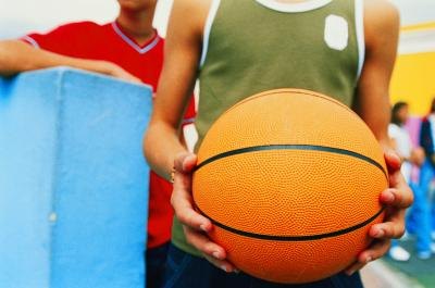 Teen boy holding basketball