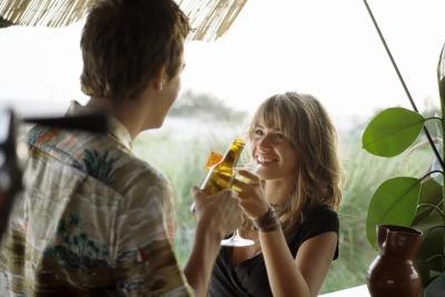 Couple toasting at outdoor bar