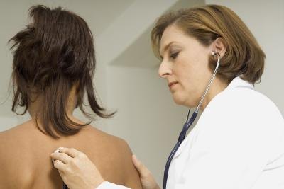 Doctor examing female patient