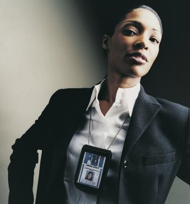A portrait of a female FBI agent with ID card.
