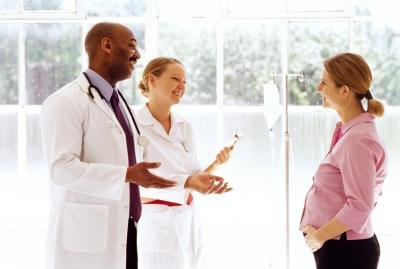 Woman talking with doctors