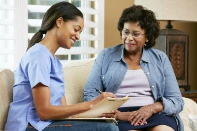 Health care worker talks to woman