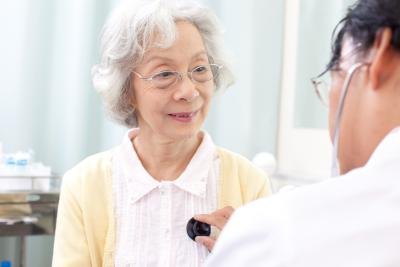 Doctor listening to senior woman's chesta