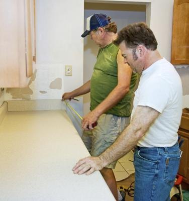 Men measure kitchen counter