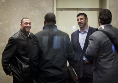 A group of men gather for an NFL contract meeting. A group of men gather for an NFL contract meeting.
