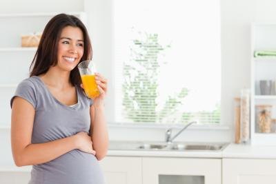 pregnant woman drinking pineapple juice