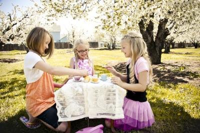 Children enjoying an outdoor tea party.