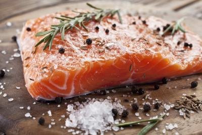 Raw salmon filet with herbs and spices.