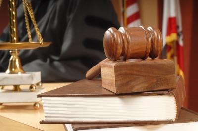 A gavel and law books on a judge's bench.