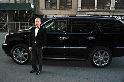 A man standing next to an Escalade