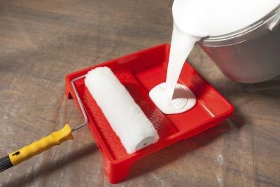 Close-up of latex paint being poured. Close-up of latex paint being poured.