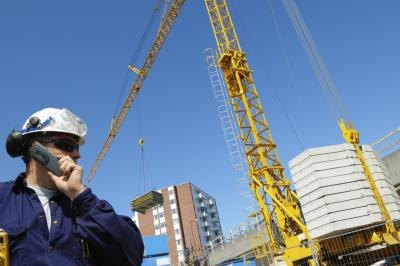 Public works director talking on a cell phone at a construction site