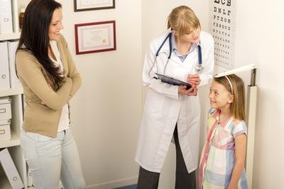 Doctor measuring child's height