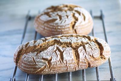Two freshly baked loaves of rye bread.