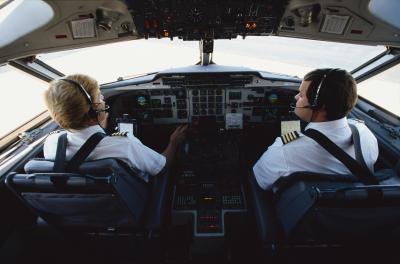Two pilots in a planes cockpit.