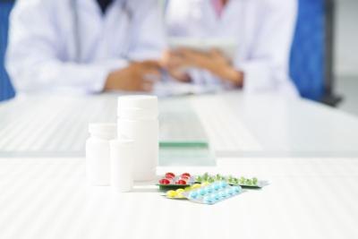 Pills and bottle on table.