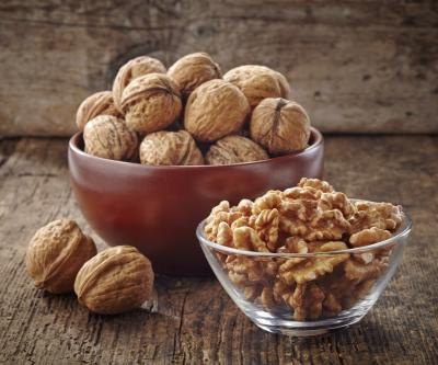 A bowl of walnuts and cracked walnuts.