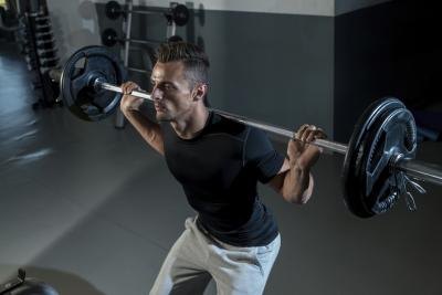 Performing squats with weights.