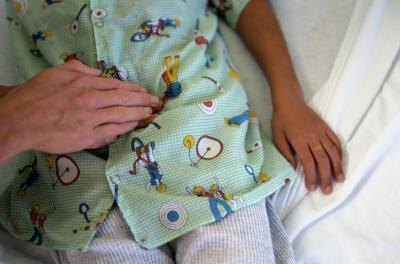 doctor pressing child's stomach