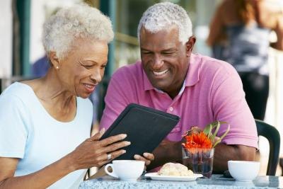 retired couple researching on an iPad
