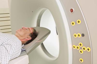 A man gets a CAT scan in a hospital.