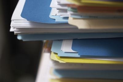 Large stack of applications and paperwork