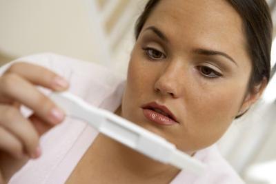 Woman looking at pregnancy test