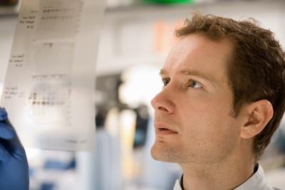 Scientist looking at results of a DNA test Scientist looking at results of a DNA test