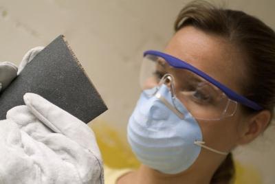 Woman wearing goggles and dust mask