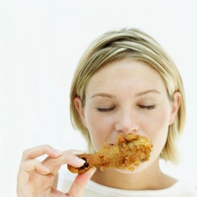 Woman eating chicken