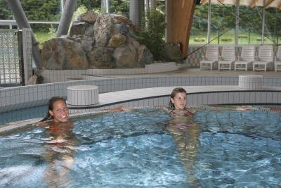 Two women in large indoor hot tub