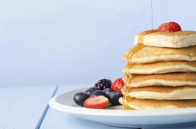 Stack of pancakes topped with berries.
