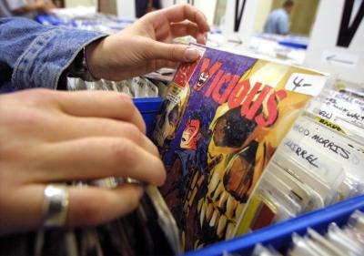 Collector browses through bins of comic books