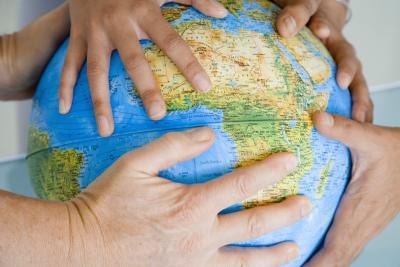 Hands on a globe. Hands on a globe.