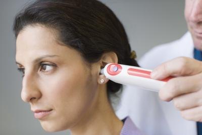 Doctor taking woman's temperature