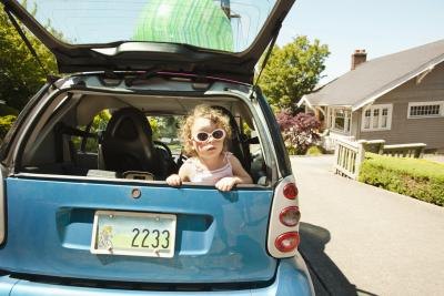 Young girl in the back of a Smart Car. Young girl in the back of a Smart Car.
