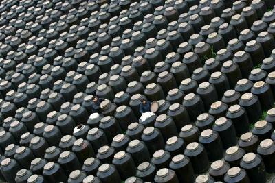 Workers inspect vinegar tanks in fermentation room of vinegar factory