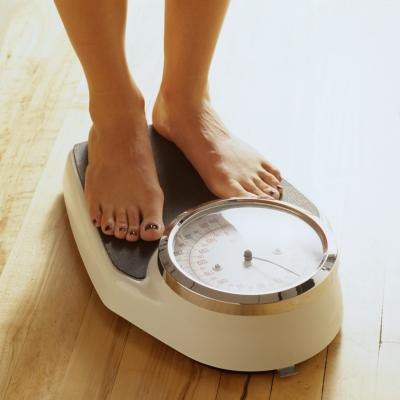 A woman on a bathroom scale A woman on a bathroom scale