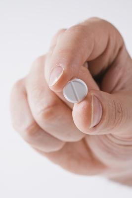 Man with pill in his hand
