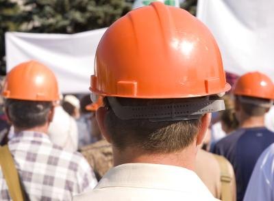 Members of a labor union wearing orange helmets.
