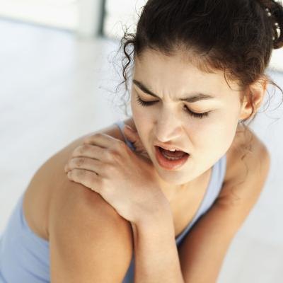 Woman experiencing right shoulder pain Woman experiencing right shoulder pain
