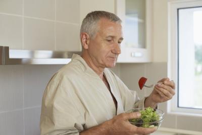 Man eating in his kitchen