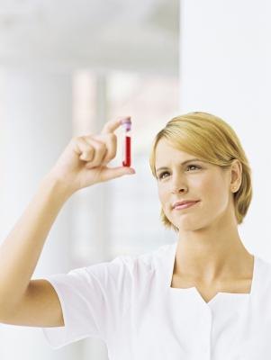 Nurse holding a test tube of blood