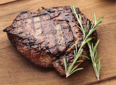 A grilled steak on a cutting board.